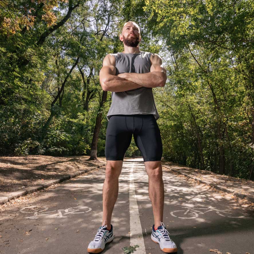 Athlete standing on a path in a park